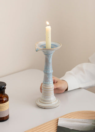 Kerzenhalter aus Keramik: blau-weißer Ständer mit Kerzenschale, Person hält ihn.