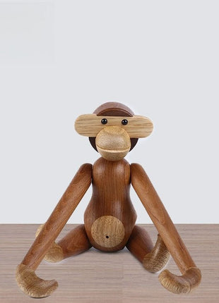 Gelenkige Holzskulptur als Affe im Sitz mit ausgestreckten Beinen