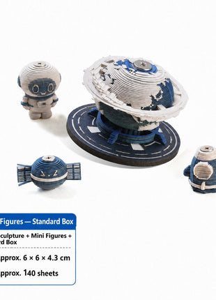 Earth paper sculpture with three miniature space figures