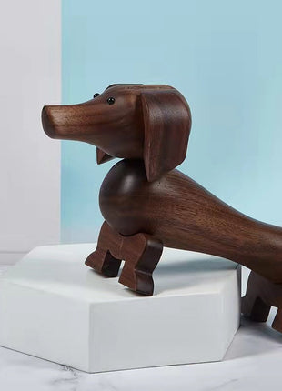Holzfigur eines Dackels aus dunklem Nussbaum mit beweglicher Drehbasis