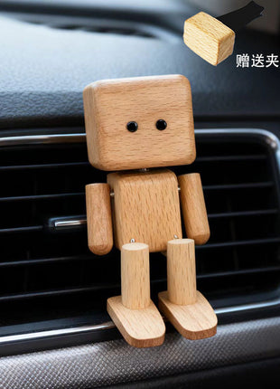 Schwingender Holz-Roboter als Auto-Duftspender, helles Holz, im Lüftungsgitter