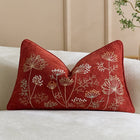 Brown dandelion lumbar pillow styled on a sofa