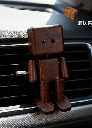 Schwingender Holz-Roboter als Auto-Duftspender, dunkelbraunes Holz, im Lüftungsgitter