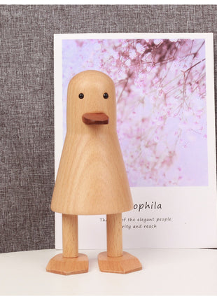 Holz-Ente aus Buche auf Sockel, gelbliche Holzoptik, brauner Schnabel, zwei Beine