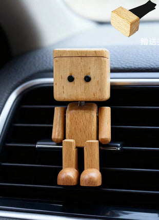 Schwingender Holz-Roboter als Auto-Duftspender, helles Holz, im Lüftungsgitter