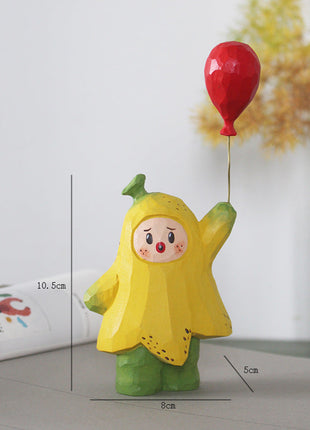Holzfigur: gelbe Sternfigur mit rotem Herzballon auf grünem Sockel