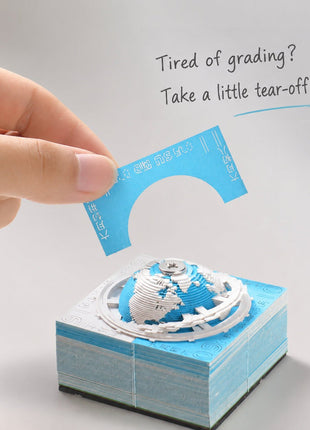 A page being peeled from an Earth paper sculpture memo pad