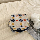Natural ivory floral embroidered mini pouch on fabric