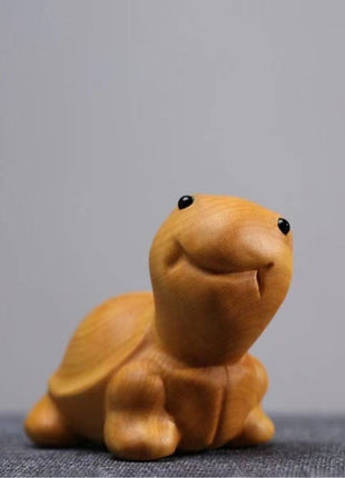 Lächelnde Schildkröten-Holzfigur aus hellgelbem Holz, nach vorn gekehrt im Stand.