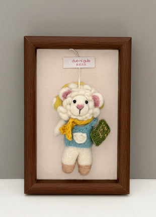 Reading sheep wool felt charm displayed in a wooden frame