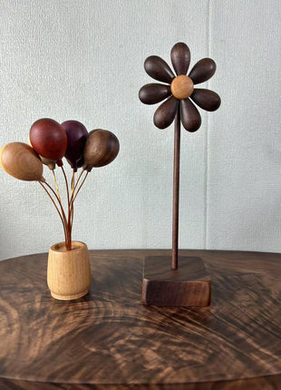 Holzblume mit Holzstab und quadratischem Standfuß, dunkelbraun mit hellem Holz-Kern