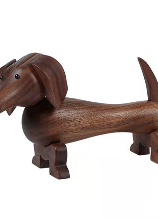 Dackel-Holzfigur aus dunklem Nussbaum, Seitenansicht mit angewinkelten Beinen