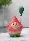 Wassermelonen-Mensch mit grünem Ballon