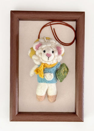 Reading sheep charm with a brown hanging cord