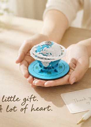 Earth paper sculpture held in two hands