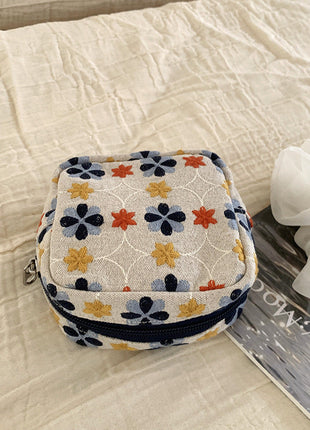 Natural ivory mini pouch with blue, orange and yellow floral embroidery