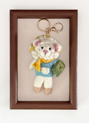 Reading sheep charm with a gold-tone keyring
