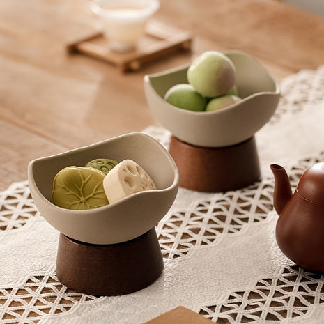 Zwei Dessertschalen aus Keramik auf Standfuß: cremefarbene Schalen, gefüllt mit Snacks