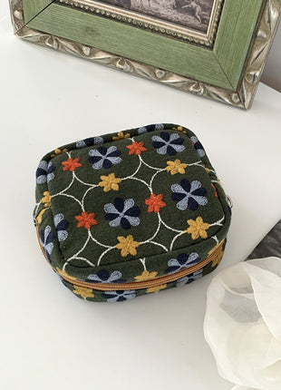 Olive green floral embroidered mini pouch with a gold-colored zipper