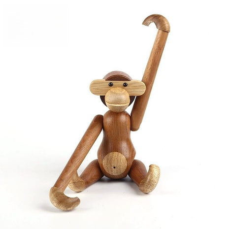 Gelenkige Holzskulptur als Affe mit ausgestrecktem Arm und gebeugten Beinen