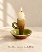 Olive green and brown glazed ceramic candle holder with loop handle and saucer base; one holder, candle not included