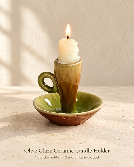 Olive green and brown glazed ceramic candle holder with loop handle and saucer base; one holder, candle not included